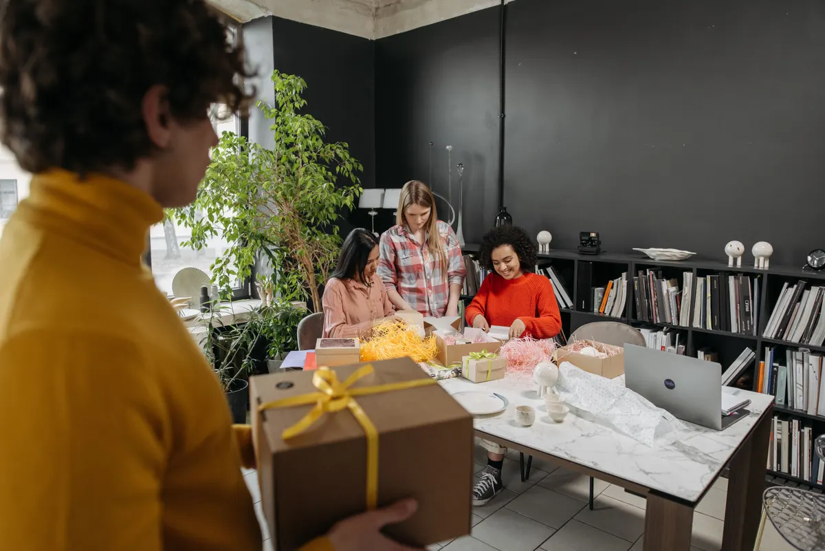 Freunde organisieren gemeinsam ein Hochzeitsgeschenk am Tisch